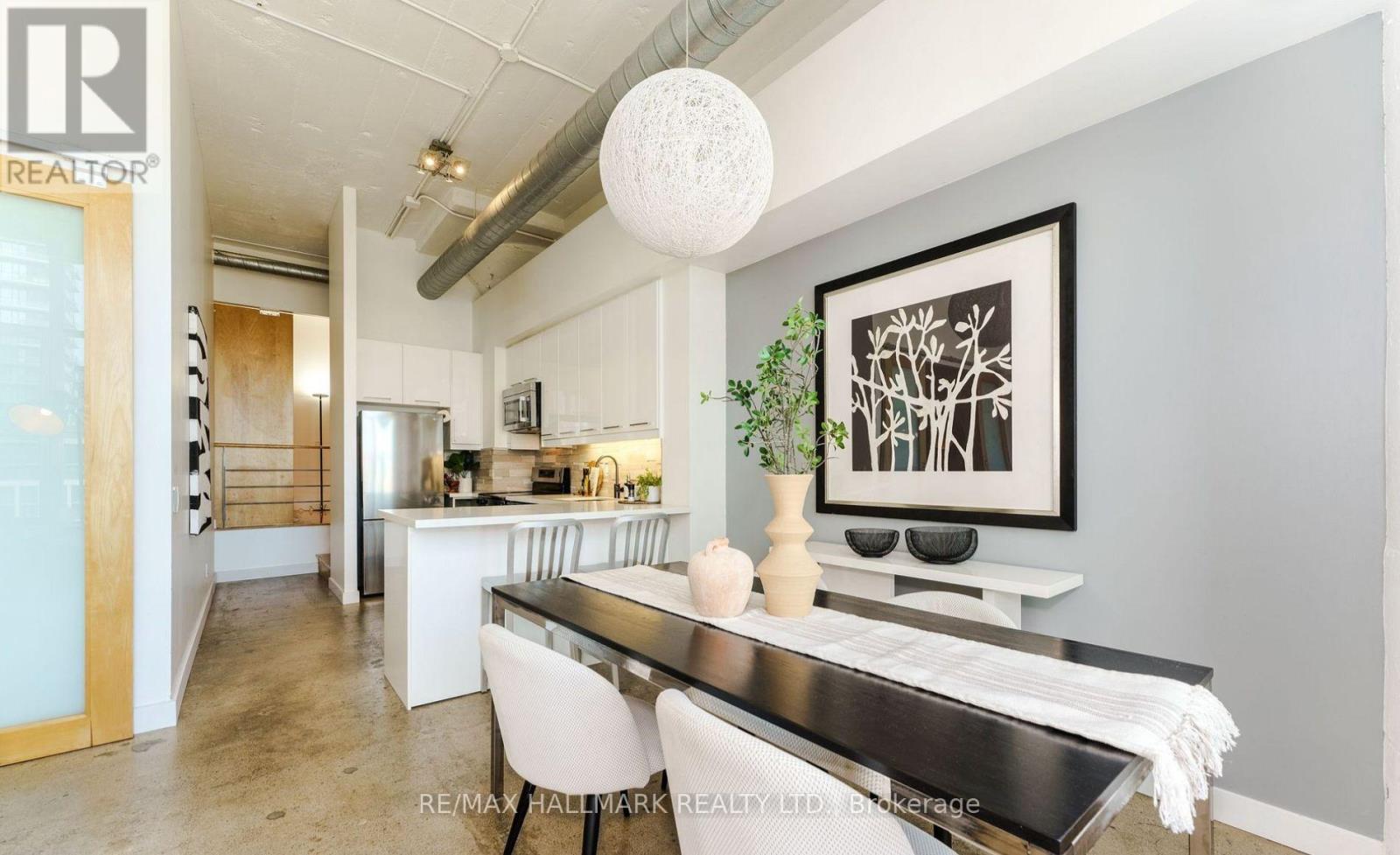 A modern kitchen with a dining table and chairs.