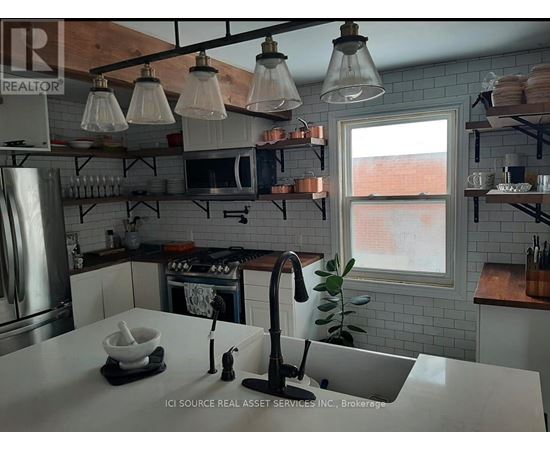 A kitchen with a white counter top and a window.