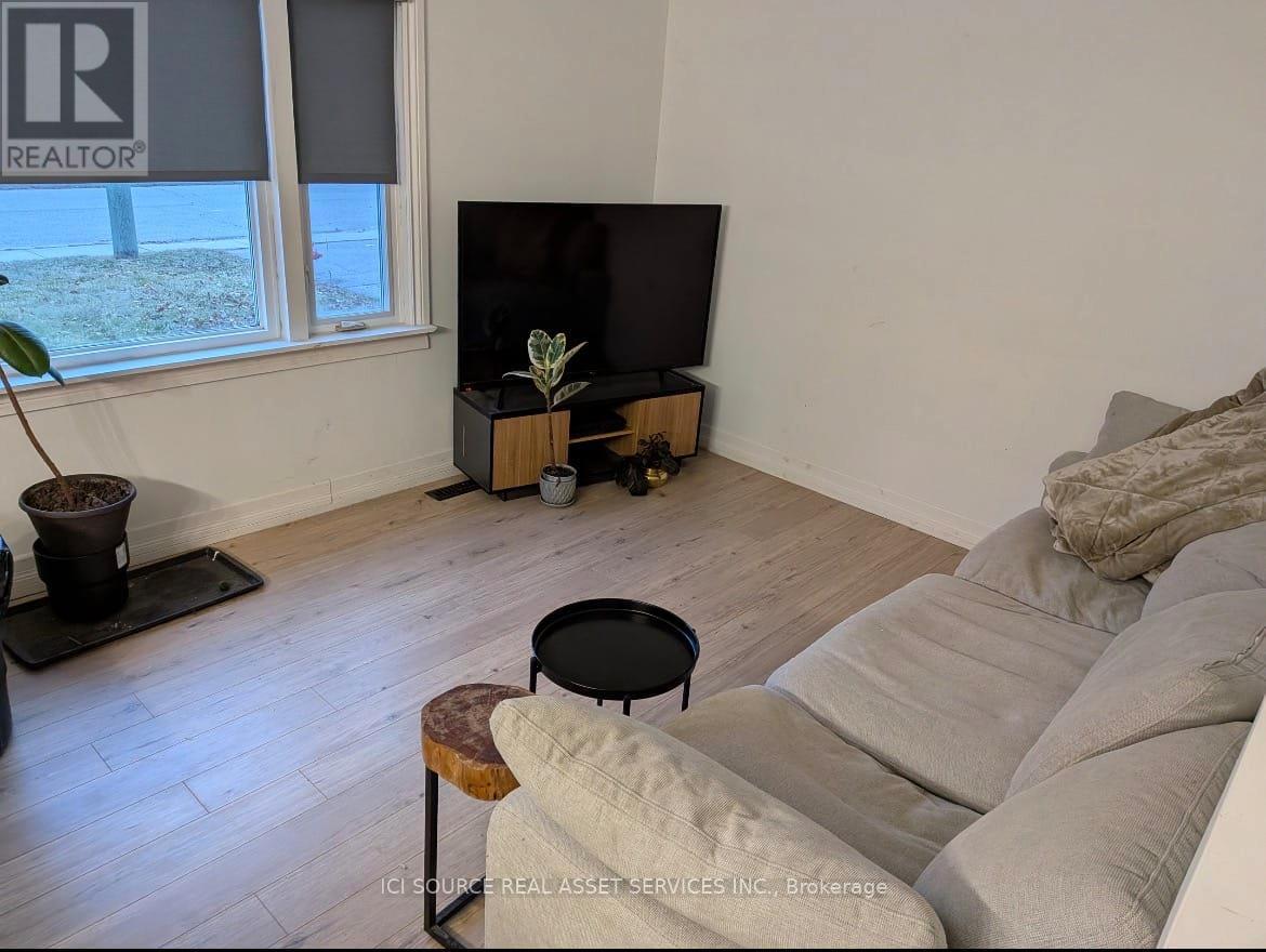 A living room with a couch, a table, and a television.