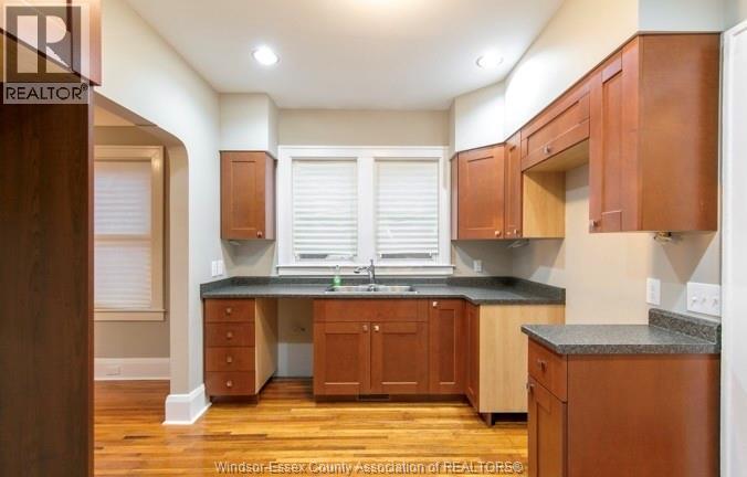 A kitchen with wooden cabinets and a granite countertop.