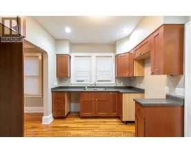 A kitchen with wooden cabinets and a granite countertop.
