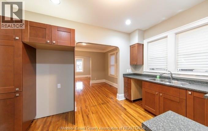 A kitchen with wooden cabinets and a refrigerator.