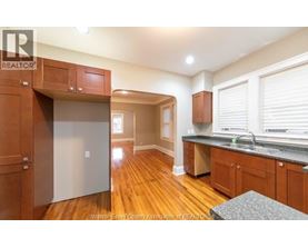 A kitchen with wooden cabinets and a refrigerator.