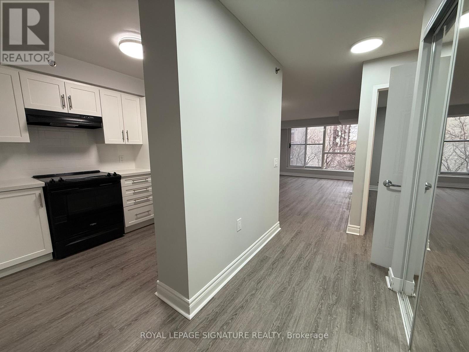 A kitchen area with a stove top oven and cabinets.