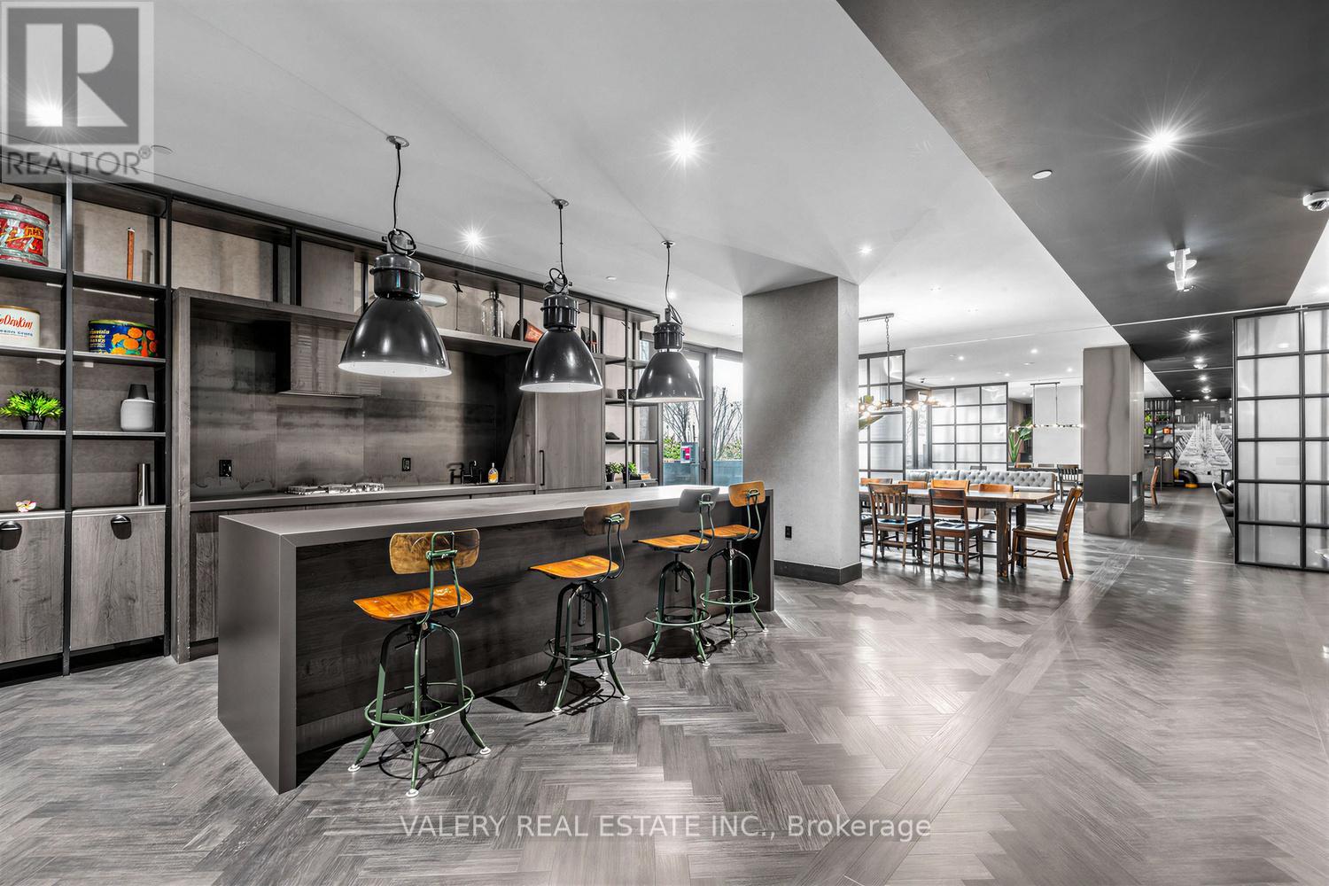 A modern kitchen with a bar area and a dining area.