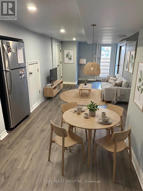 A modern kitchen with a dining table set for two.