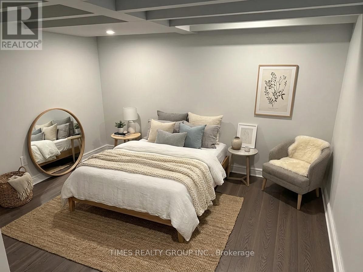 A bedroom with a bed, chair, and mirror.