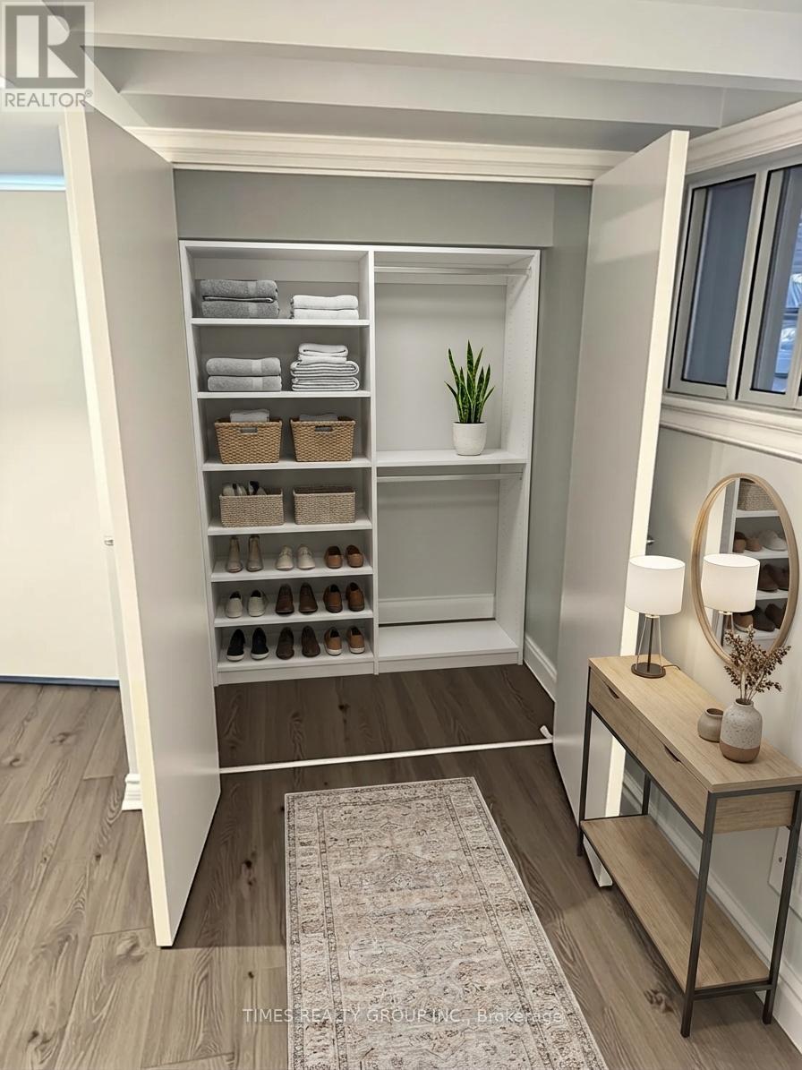 A small closet with a mirror and a table with a plant on it.