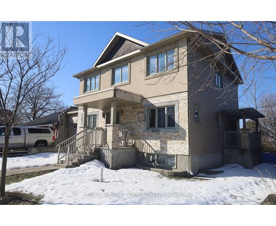 A two-story house with a garage and a car parked in front.