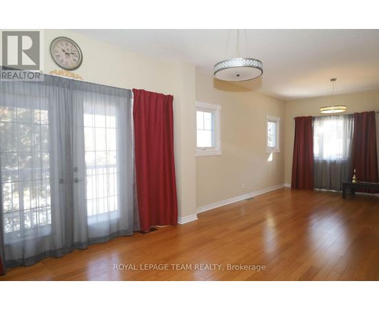 A room with wooden floors and red curtains.
