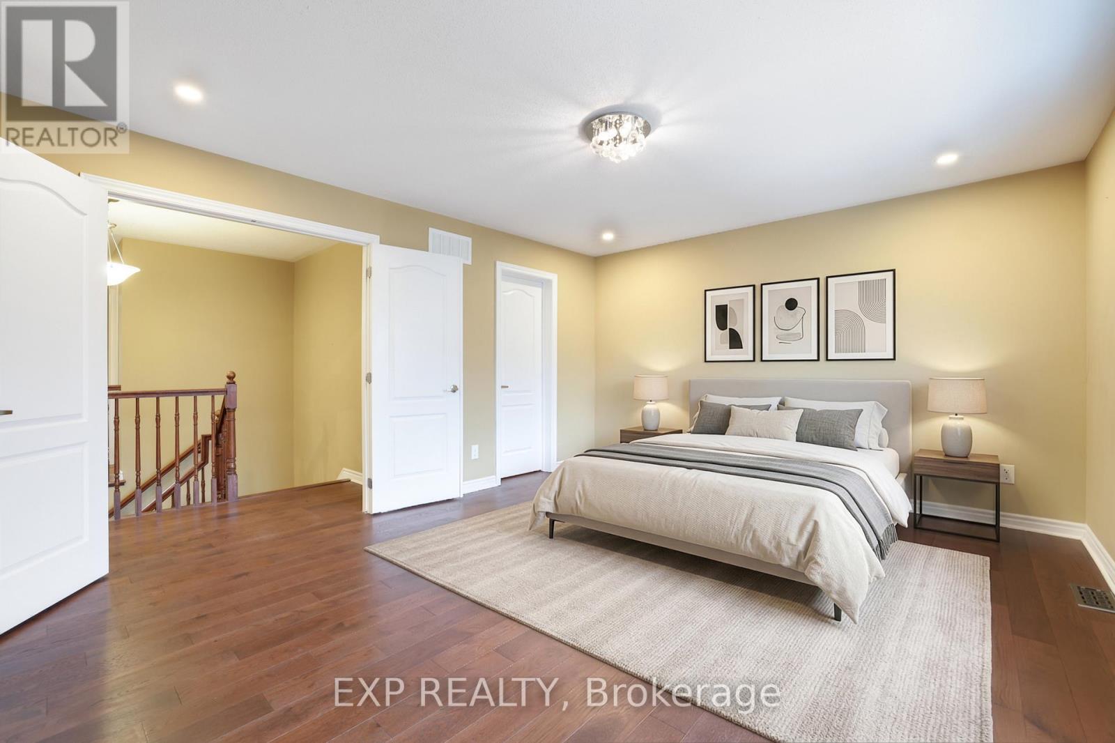 A bedroom with a bed, nightstands, and a rug.