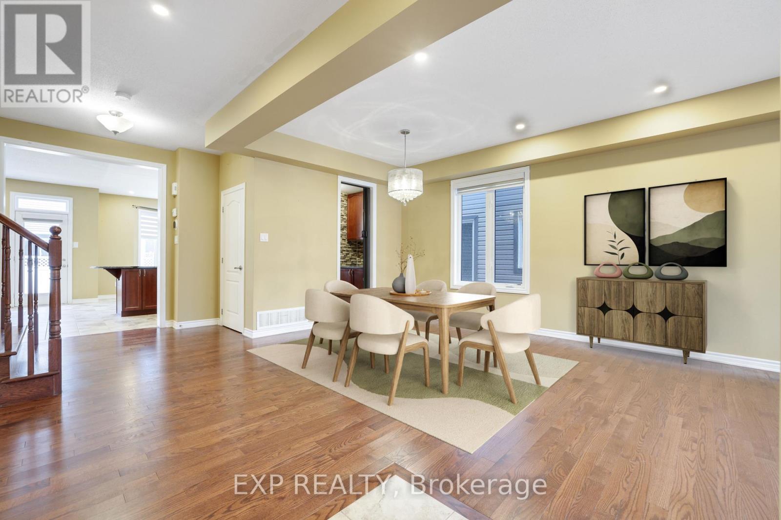 A dining room with a wooden table and chairs.