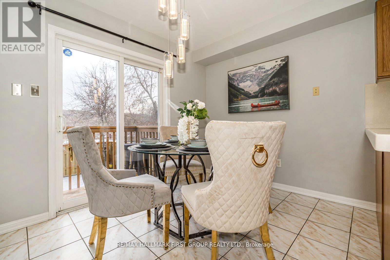 A dining room with a table set for two and a view of the outdoors.