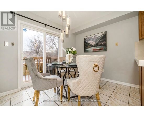 A dining room with a table set for two and a view of the outdoors.