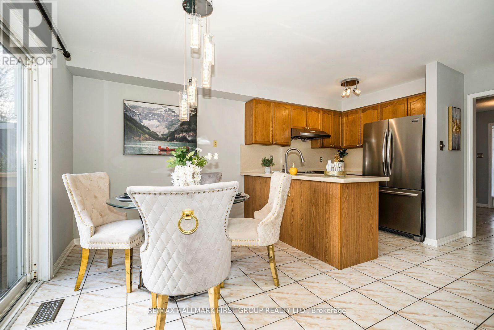 A kitchen with a dining table and chairs.