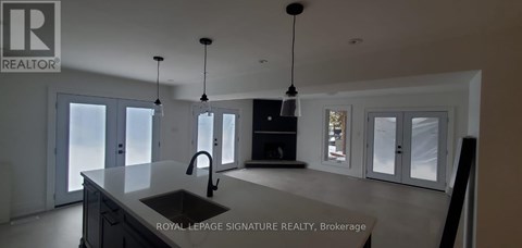 A modern kitchen with a sink and a large island.