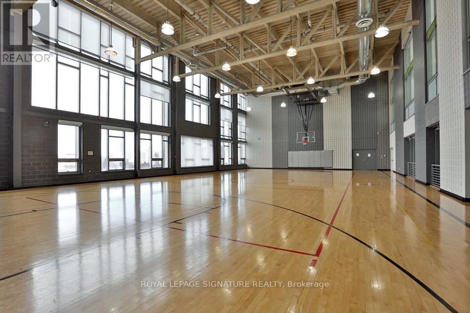 A gym with wooden floors and a basketball court.