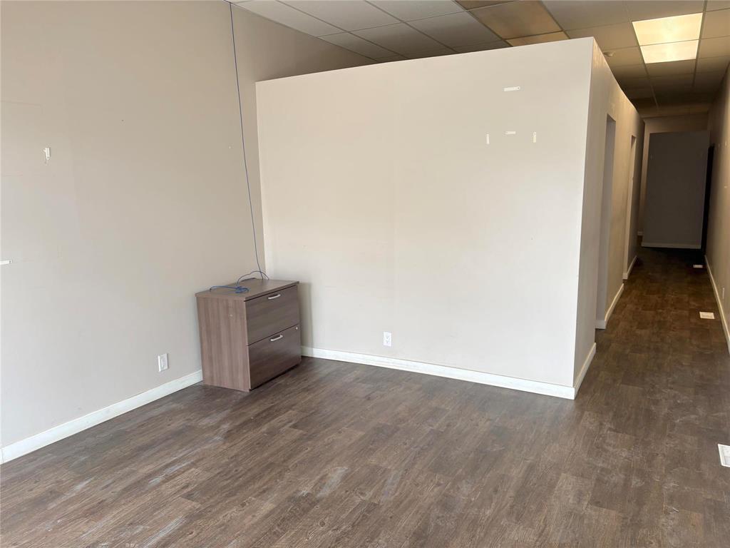 A room with a filing cabinet and a white wall.