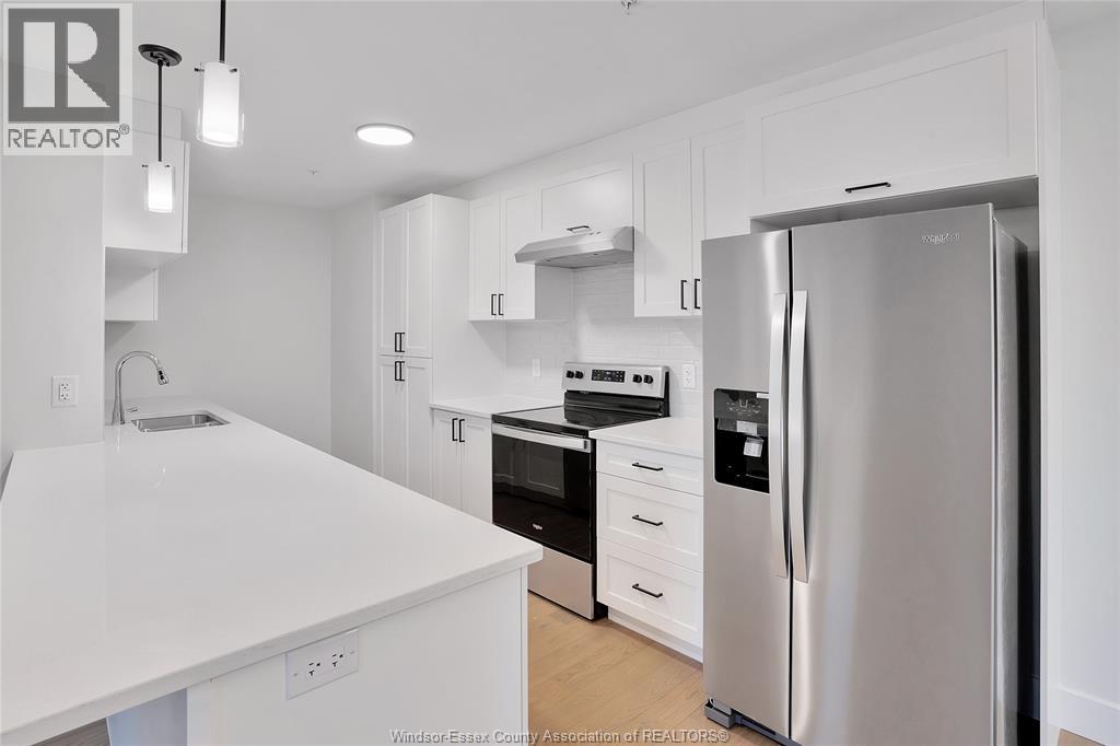 A modern kitchen with white appliances and cabinets.