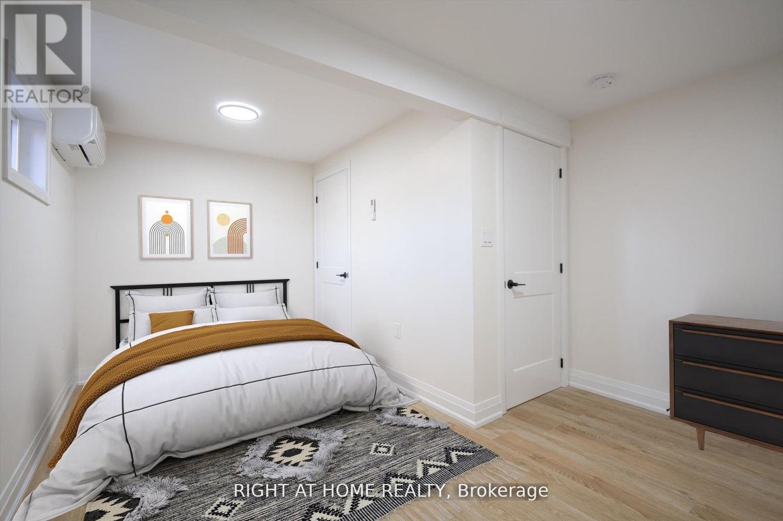 A bedroom with a bed, dresser, and two pictures on the wall.