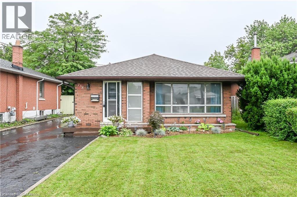 A house with a green lawn in front.