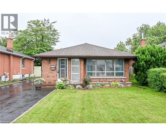A house with a green lawn in front.