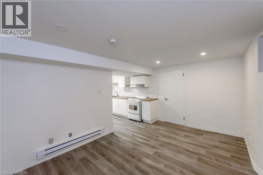 A well-lit kitchen with wooden floors and white walls.