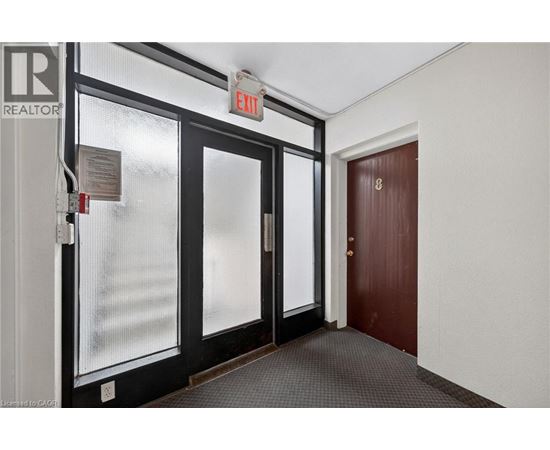 A hallway with a red door and a sign that says "REALTOR".