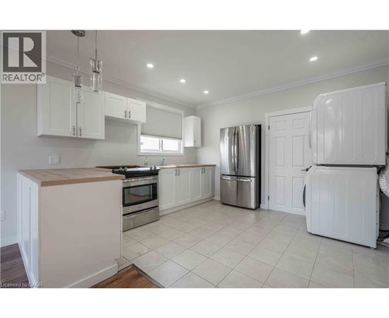 A kitchen with white cabinets and appliances.