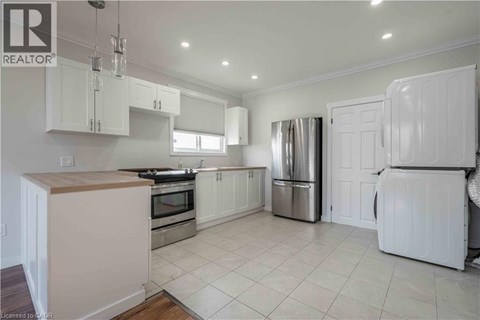 A kitchen with white cabinets and appliances.