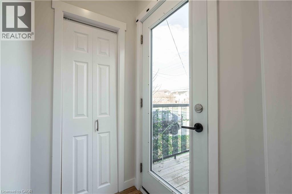 A white door with a glass window is open.