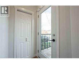 A white door with a glass window is open.