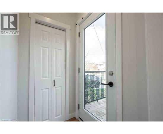A white door with a glass window is open.