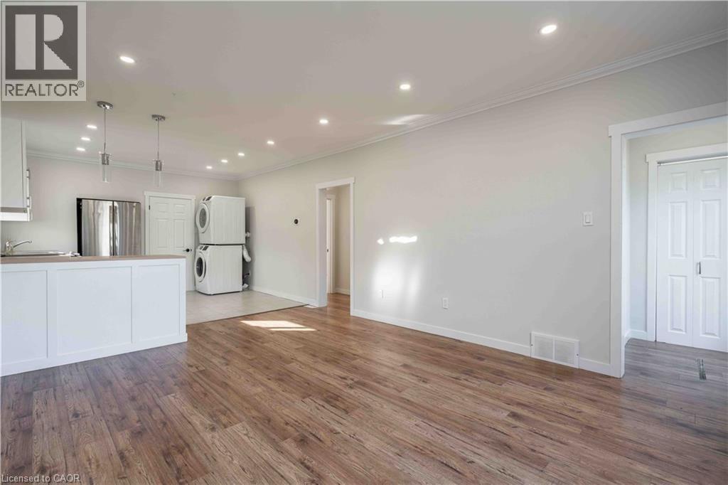 A large empty room with wooden floors and white walls.