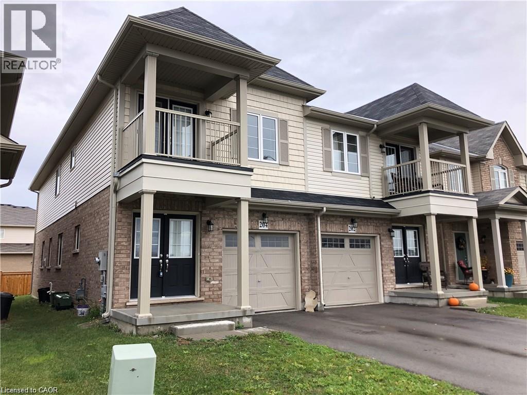 A two-story house with a garage and a balcony on the second floor.