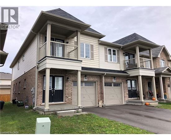 A two-story house with a garage and a balcony on the second floor.