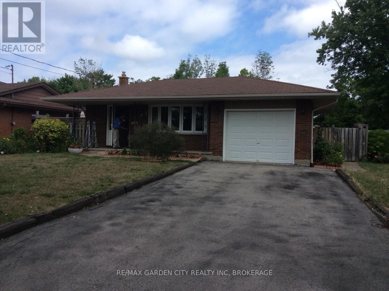 A house with a brown roof and a white garage door.