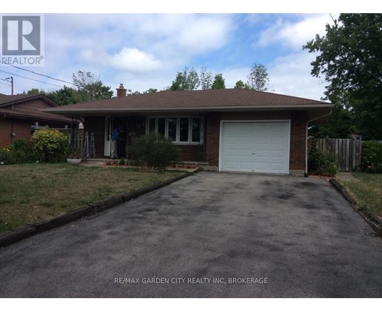 A house with a brown roof and a white garage door.