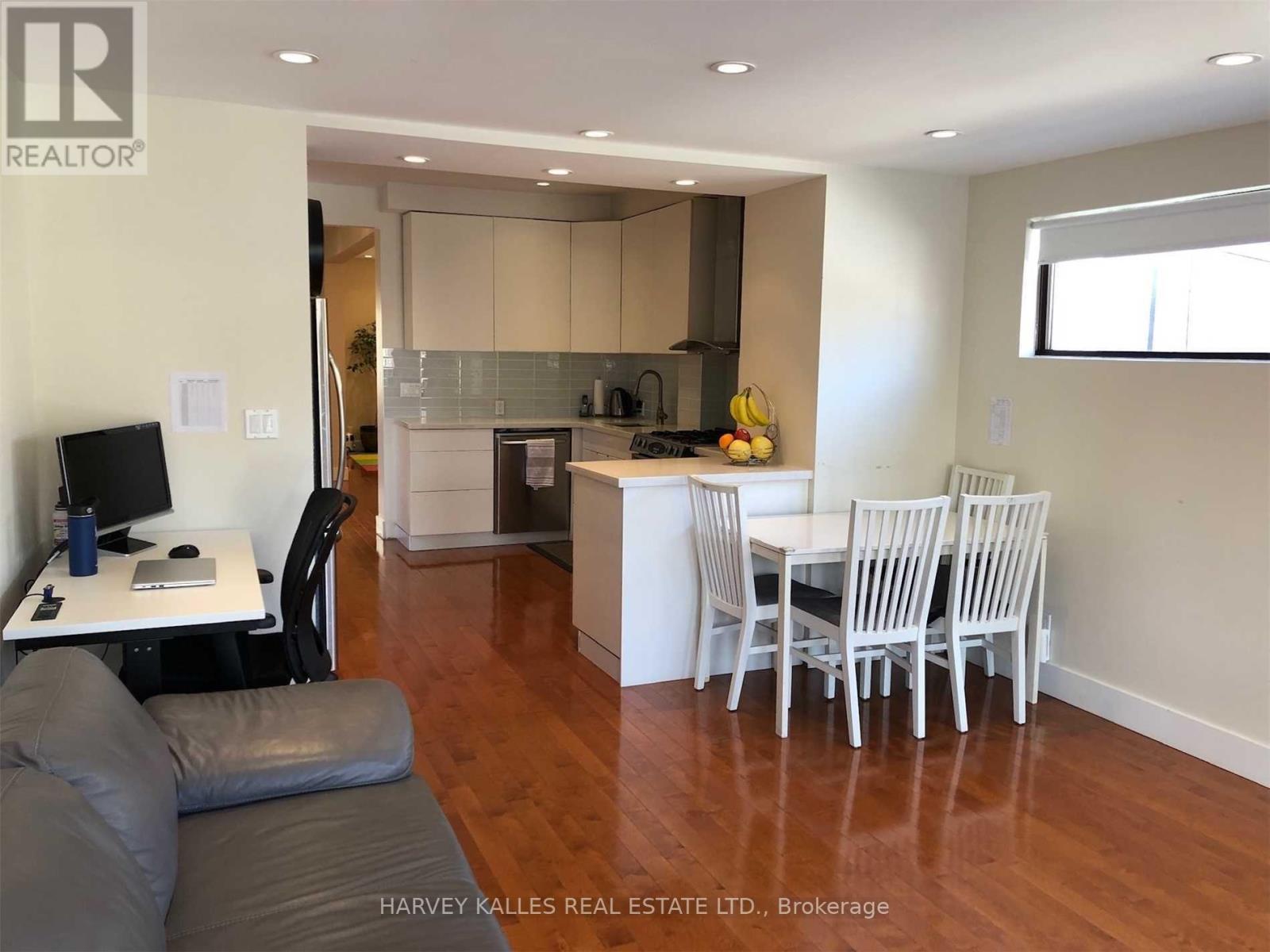 A modern kitchen with a dining table and chairs.
