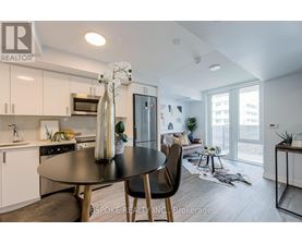 A modern kitchen with a dining table and chairs.