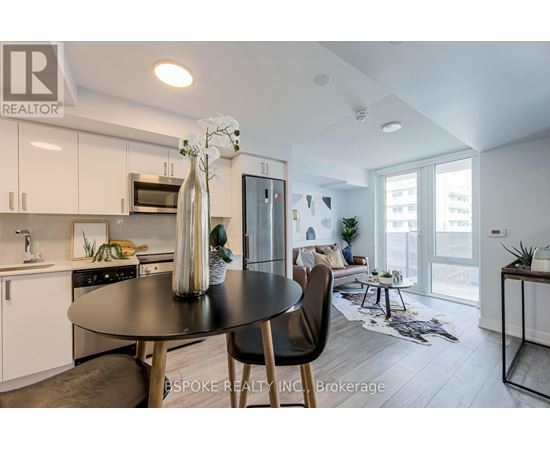 A modern kitchen with a dining table and chairs.