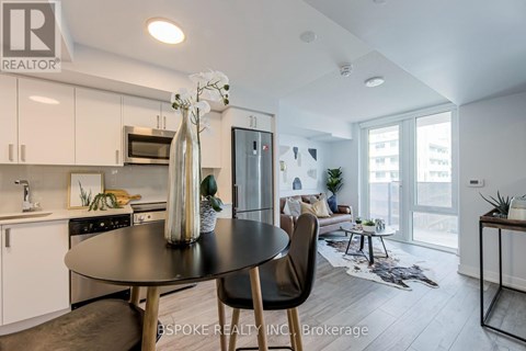 A modern kitchen with a dining table and chairs.
