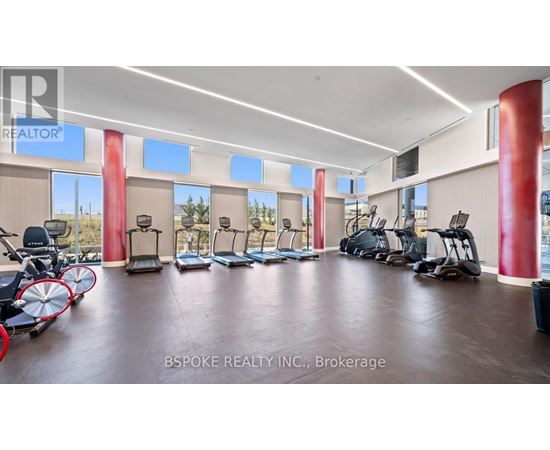 A gym with exercise equipment and a sign that says REALTOR.