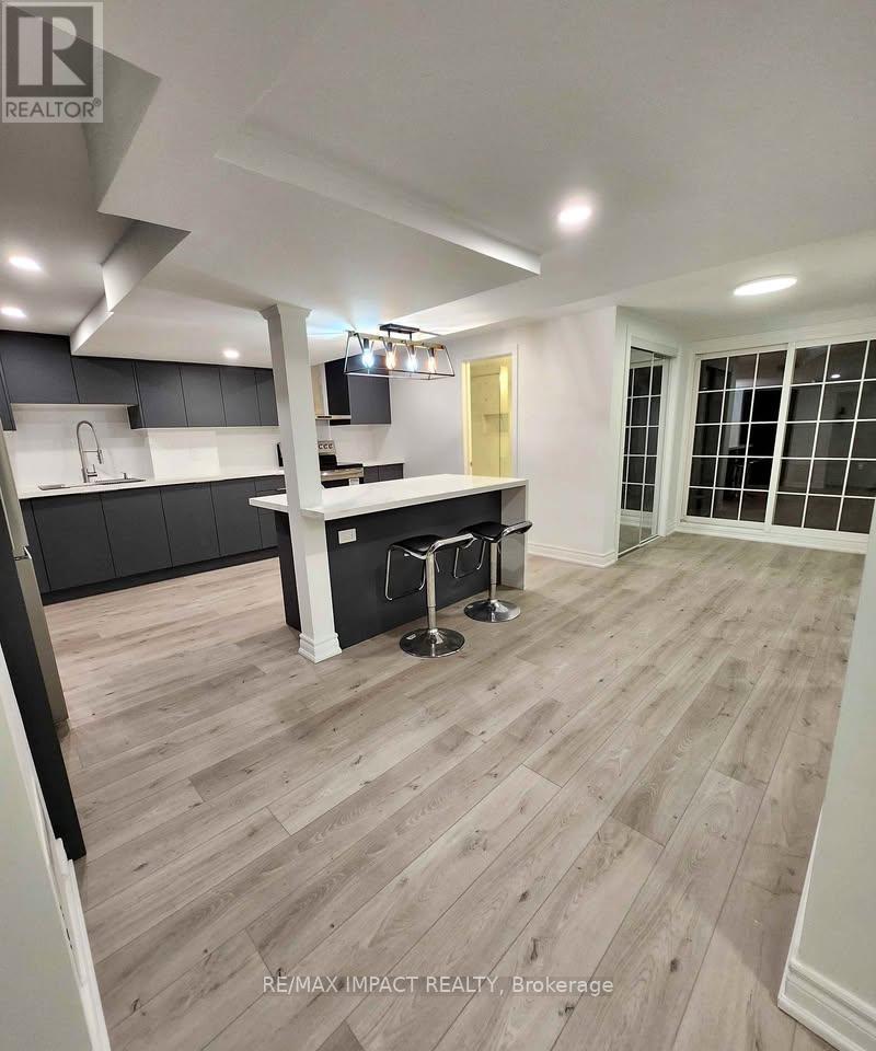 A modern kitchen with a bar stool and a countertop.
