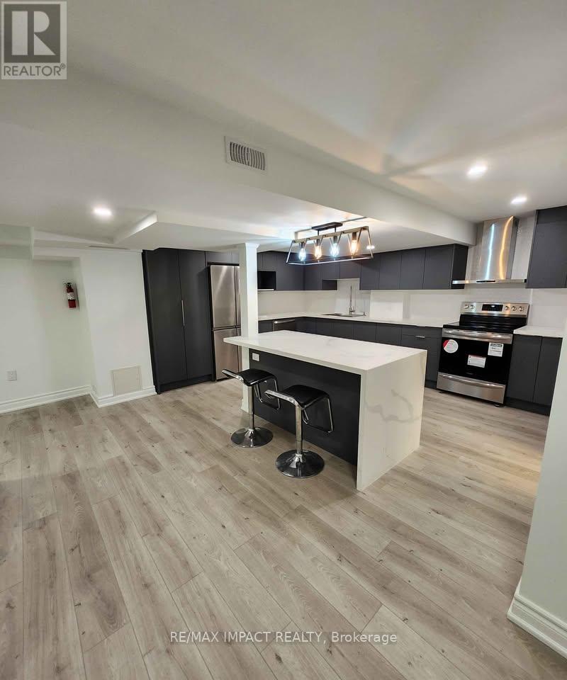 A modern kitchen with a bar stool in front of a counter.