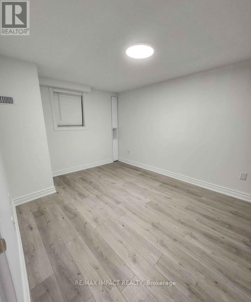 A room with a wooden floor and white walls.