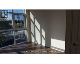 A room with a view of a street through a window.