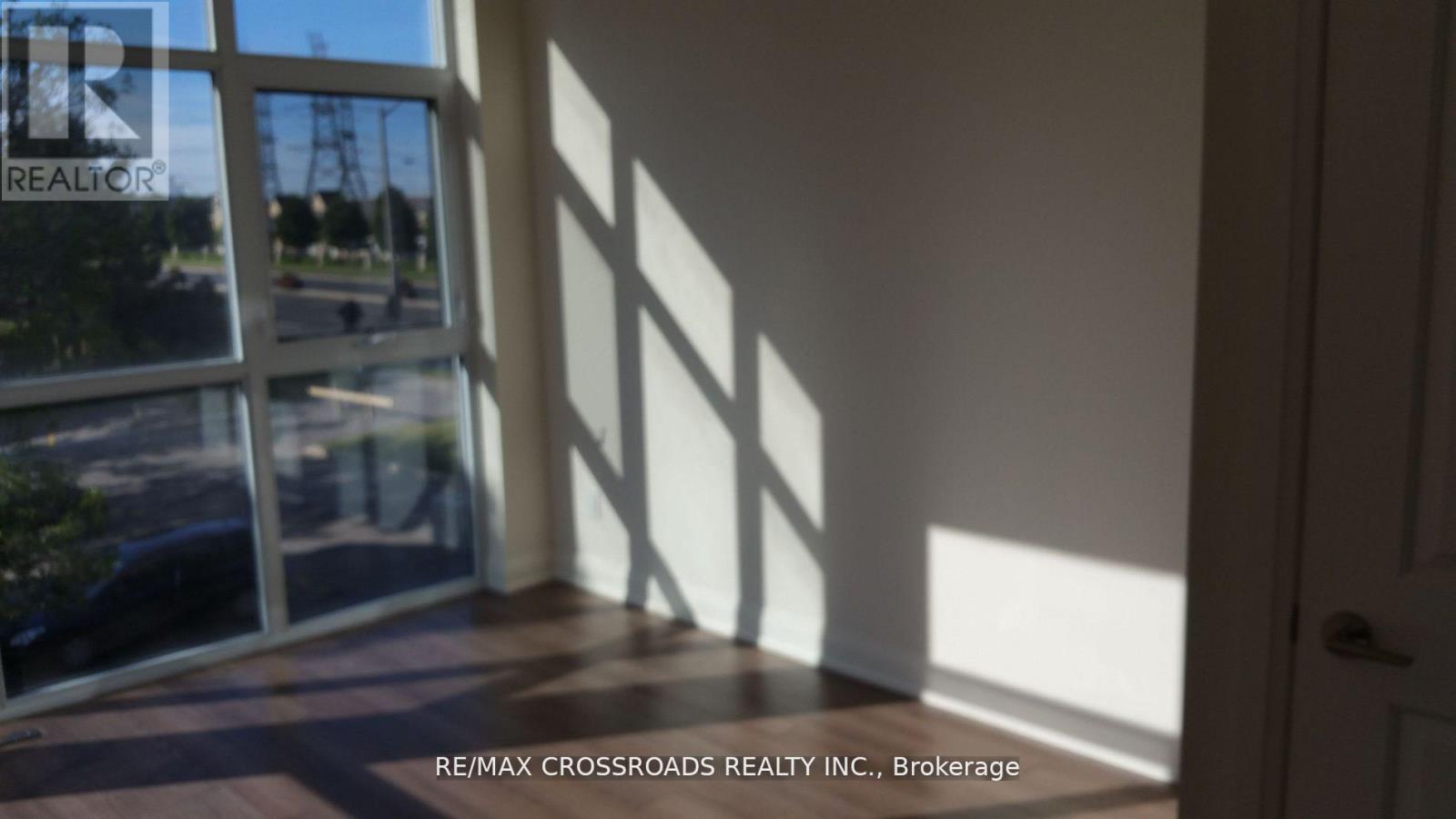 A room with a view of a street through a window.