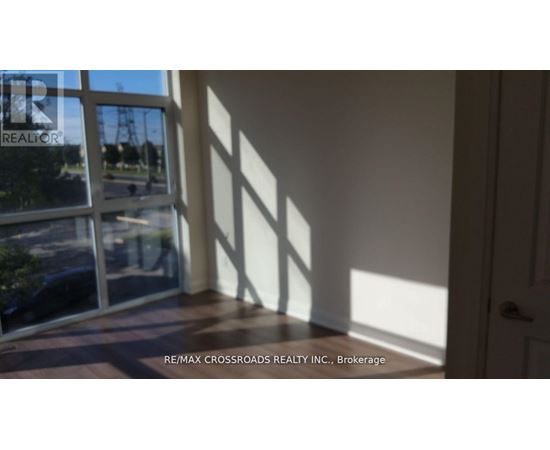 A room with a view of a street through a window.