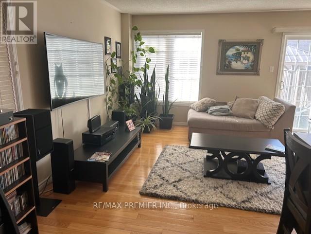 A living room with a couch, a television, and a rug.